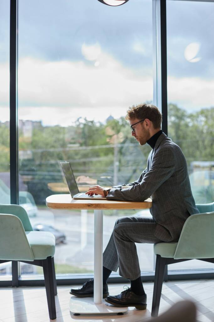 Full-length portrait of a successful programmer working on IT software in a modern office interior